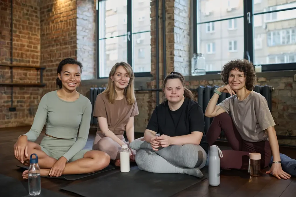 Disabled girl doing a yoga class with friends