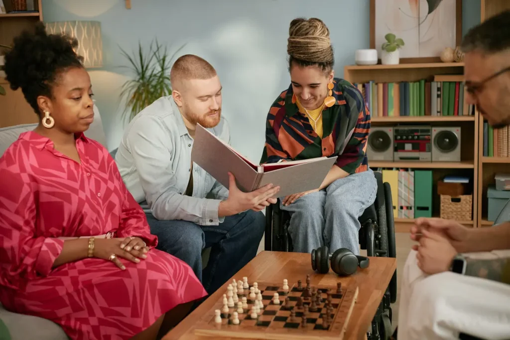 Friends and carers helping disabled woman look over paperwork
